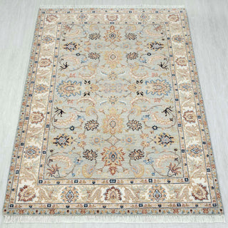 4x6 ft light green hand-knotted rug in cream rust gold with open floral design.