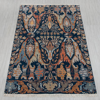 5x8 Persian-style hand-knotted rug in navy rust orange with floral vine design.