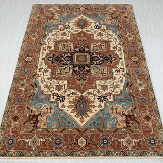 6x9 Heriz-style oriental rug with central medallion, terracotta and ivory field, and floral geometric borders