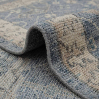8x10 Turkish Oushak-inspired hand-knotted rug with soft floral motif in slate blue and tan neutrals.