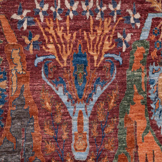 8x10 ft Hand-knotted wool rug featuring central palmette pattern in red teal orange ivory.