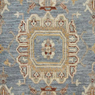 9x12 Hand-knotted wool rug featuring sparse floral pattern in denim ivory rust, low-pile durable.