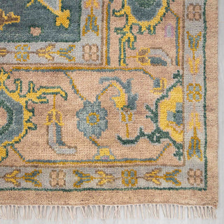 Modern hand-knotted rug with abstract geometric pattern in blush, teal, and mustard for large rooms.