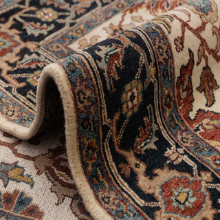 Agra-style hand-knotted rug with classic floral motifs in ivory, navy, rust, and blue, medium 5x7 area.