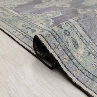 Caucasian Kazak-style hand-knotted rug with geometric medallion motif in gray, green, ivory tones.