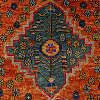 Caucasian village hand-knotted rug with stepped medallion and floral motifs in terracotta and teal.