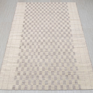  Checkered hand-knotted rug in ivory taupe with geometric checkerboard design. 8x10 ft low-pile wool.