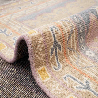 Contemporary Khotan-style hand-knotted rug with tribal geometric motif in sand, slate, and lilac hues.

