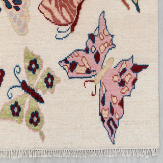 Contemporary hand-knotted rug with playful butterfly pattern in soft multicolor on ivory ground, 9x12