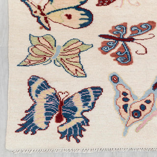 Contemporary hand-knotted rug with playful butterfly pattern in soft multicolor on ivory ground, 9x12
