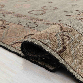 East Turkestan Khotan-style hand-knotted rug with geometric medallion motif in soft green and gold