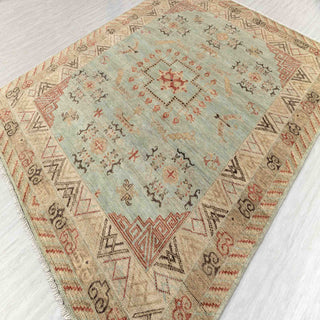 East Turkestan Khotan-style hand-knotted rug with geometric medallion motif in soft green and warm neutrals