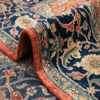 Ferehan-style hand-knotted rug with repeating floral motifs in rust, blue, and beige, classic 10x14 Persian look