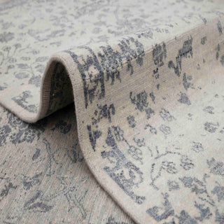 Floral hand-knotted rug in ivory gray with vine design. 8x10 ft wool area rug.