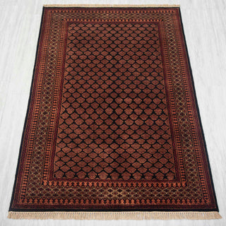 Gabbeh-style hand-knotted rug in black, rust, gold with small boteh lattice design, 4x6 ft