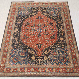 Hand-knotted 10x14 ft Persian Heriz rug showcasing rich red oval medallion on navy indigo ground, surrounded by geometric floral motifs in cream ivory and teal tones