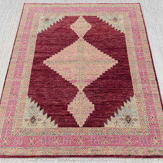 Hand-knotted geometric rug in burgundy, pink, and beige diamond design, approx 8x10 size.