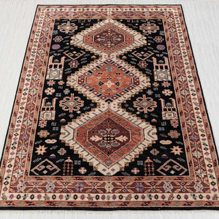 Hand-knotted rug in black, rust, and cream with tribal geometric medallion design