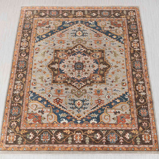 Hand-knotted rug in blue, rust, and ivory with central medallion and floral border, 12x15.

