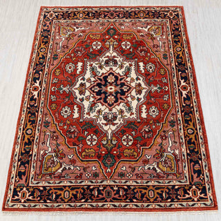 Hand-knotted rug in brick red, ivory and navy with classic Persian medallion and floral pattern design.