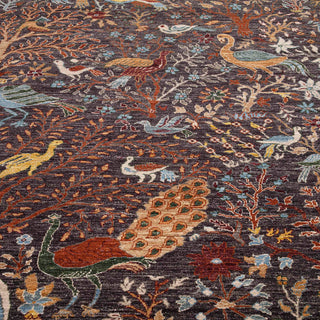 Hand-knotted rug in charcoal, rust and teal with pictorial bird and tree-of-life forest pattern design.