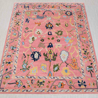 Hand-knotted rug in coral pink, navy and multicolor with playful modern Oushak floral pattern design