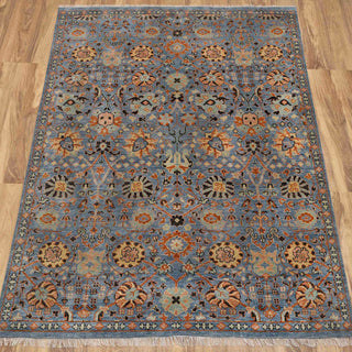 Hand-knotted rug in denim blue and rust with traditional allover Herati floral lattice design.