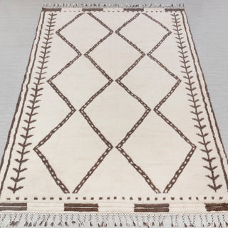 Hand-knotted rug in ivory and chocolate brown with tribal diamond and vine border pattern design