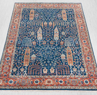 Hand-knotted rug in navy blue, rust and gold with detailed Persian garden pattern design.