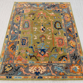 Hand-knotted rug in olive green and slate grey with bold tribal allover pattern design.