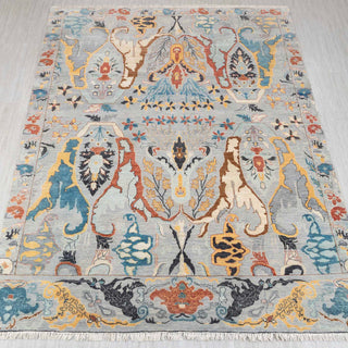 Hand-knotted rug in soft gray-blue with bold abstract botanical pattern, ideal statement 8x10 area.