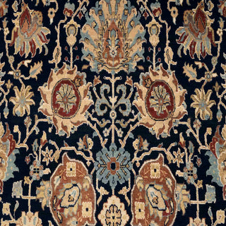 Hand-knotted wool area rug featuring navy field, rust floral border, 9x12 size for living room