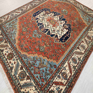 Hand-knotted wool rug featuring Caucasian geometric medallion in rust, blue, ivory, 8x10.