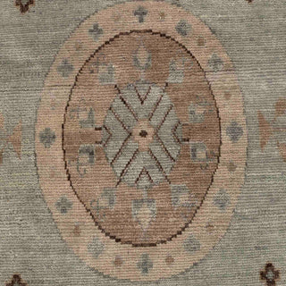 Hand-knotted wool rug featuring Khotan medallion and tribal motifs in green, beige, brown, 10x14.
​


