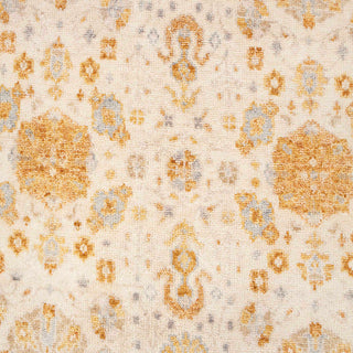 Hand-knotted wool rug featuring Oushak floral pattern in ivory, honey gold, soft blue, 8x10 size.

