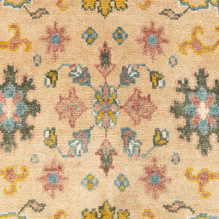 Hand-knotted wool rug featuring Oushak floral pattern in warm beige, mustard, blue, 8x10 size.