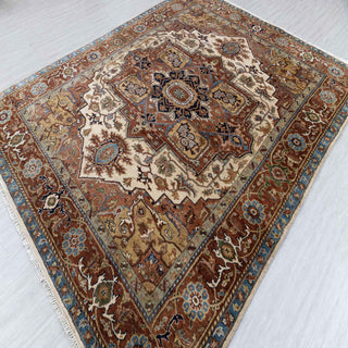 Hand-knotted wool rug featuring Persian medallion pattern in rust, cream, blue, 8x10 feet.