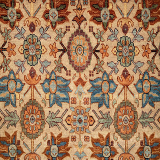Hand-knotted wool rug featuring allover floral lattice pattern in warm beige field with rust and blue accents, 9x12 ft.