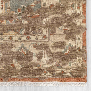 Hand-knotted wool rug featuring central medallion and floral Oushak pattern in rust, blue, cream, 9x12 size.