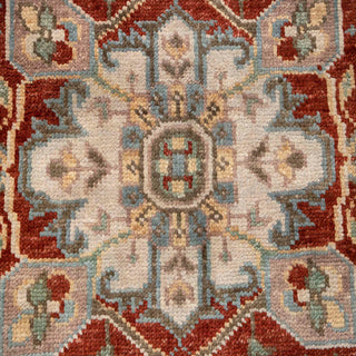 Hand-knotted wool rug featuring central medallion, blue field, ivory floral border, rust accents, 8x10.
