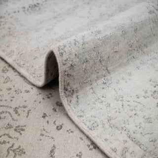 Hand-knotted wool rug featuring central medallion pattern in tonal grey, 9x12 feet.