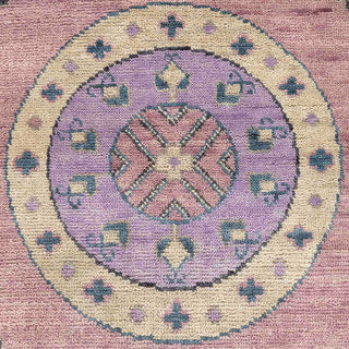 Hand-knotted wool rug featuring central medallions and tribal motifs in blush, lilac, teal, 9x12 ft