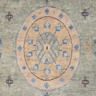 Hand-knotted wool rug featuring circular medallions and geometric symbols in green, gold, blue, 10x14.