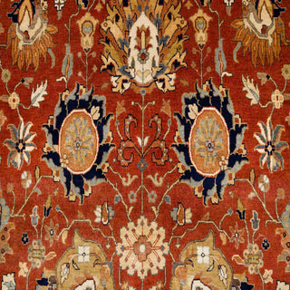 Hand-knotted wool rug featuring classic allover floral pattern in rust field with navy and gold border, 10x14 ft.