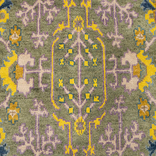 Hand-knotted wool rug featuring colorful Oushak floral pattern in green, purple, yellow, 8x10 size.
