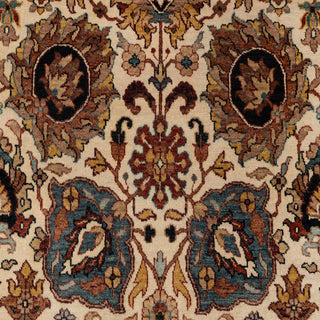 Hand-knotted wool rug featuring detailed floral pattern on ivory field with navy border, 5x7 ft for living room.