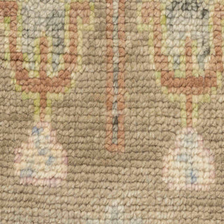 Hand-knotted wool rug featuring earth-tone floral pattern in brown, beige, pastels, 8x10 size.