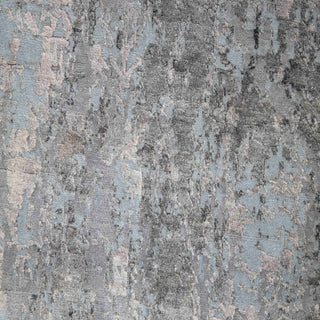 Hand-knotted wool rug featuring faded marbled pattern in grey silver blue, 9x12 feet.