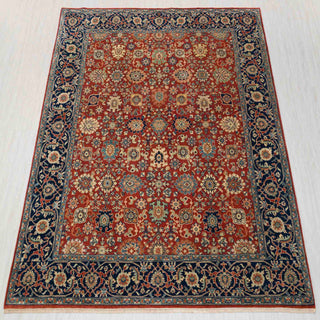 Hand-knotted wool rug featuring fine allover floral motifs in rust field with navy border, ideal 8x10 living room area.