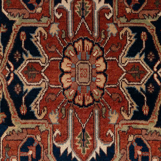 Hand-knotted wool rug featuring geometric Heriz medallion and corner motifs in rust, cream, and navy, 6x9 ft.